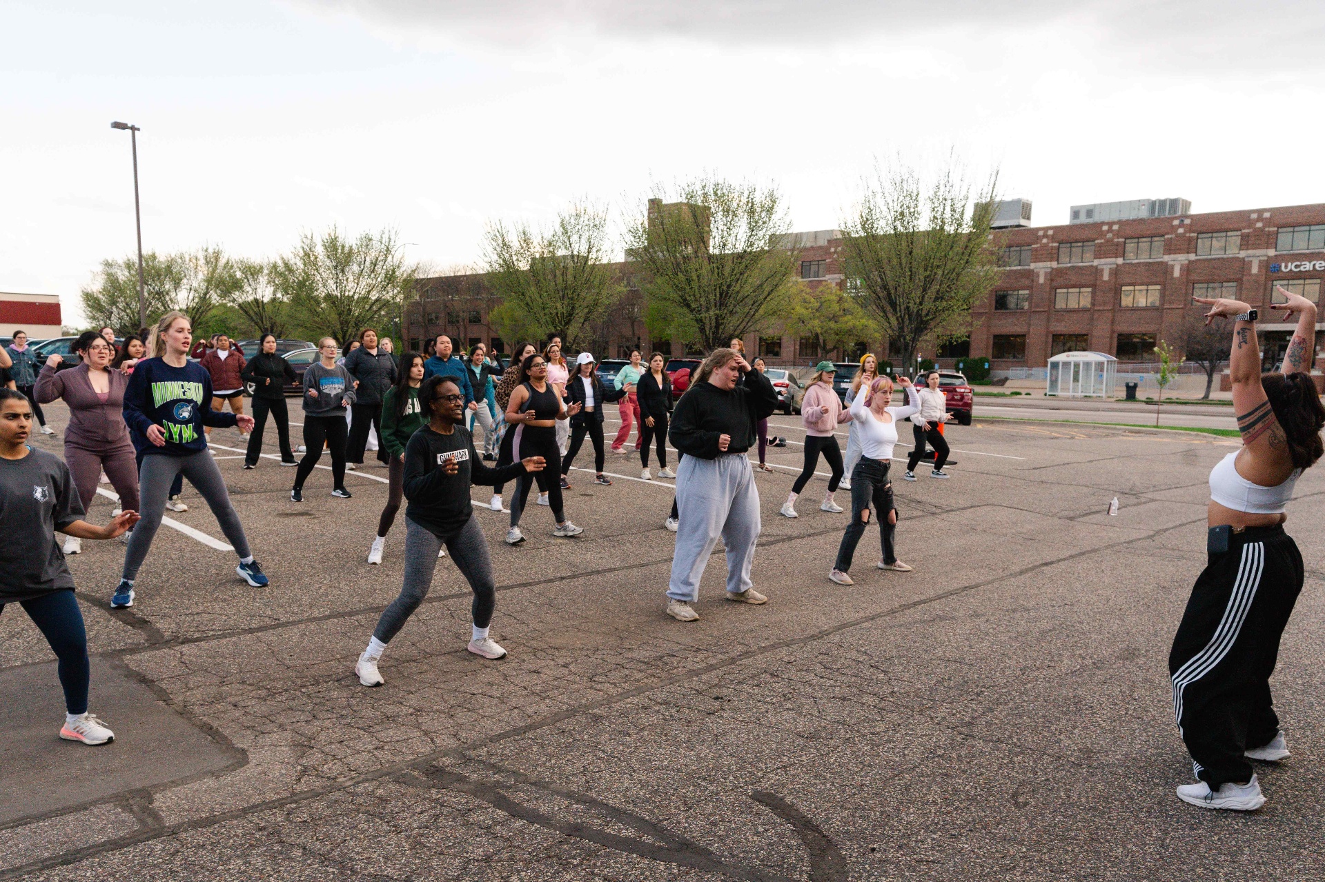 Outdoor parking-lot Turn Up class with dozens of dancers in motion