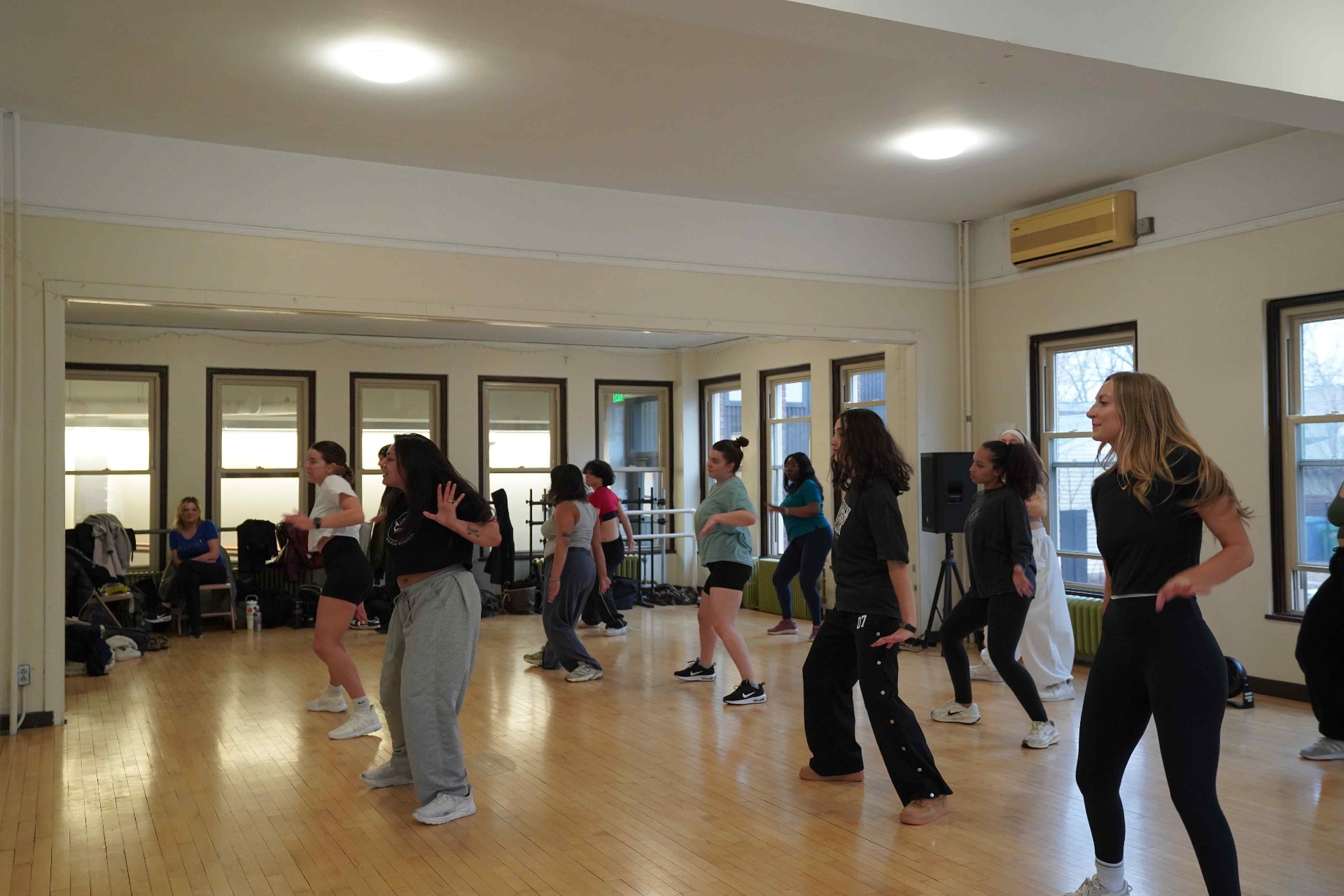 Indoor studio Turn Up Dance Fitness class with a wood floor and tall windows