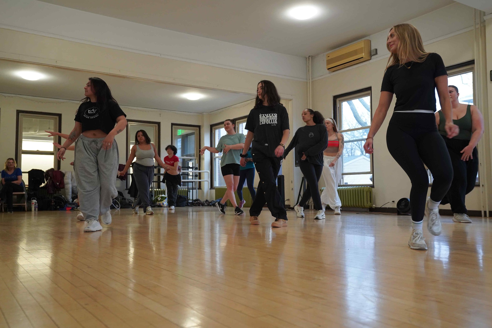 Dancers grooving in line during an indoor Turn Up class